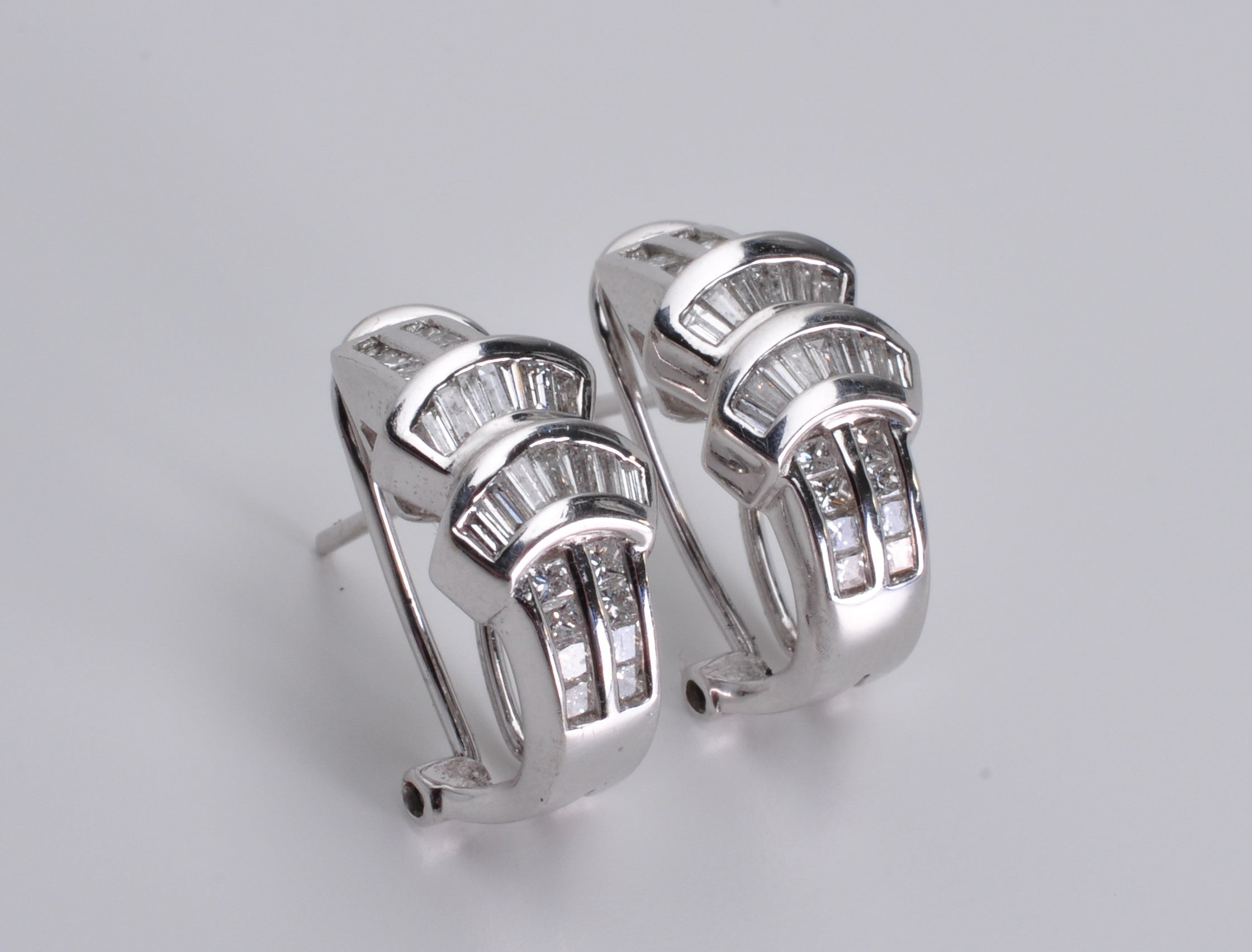 Diamond drop earrings on a dark background