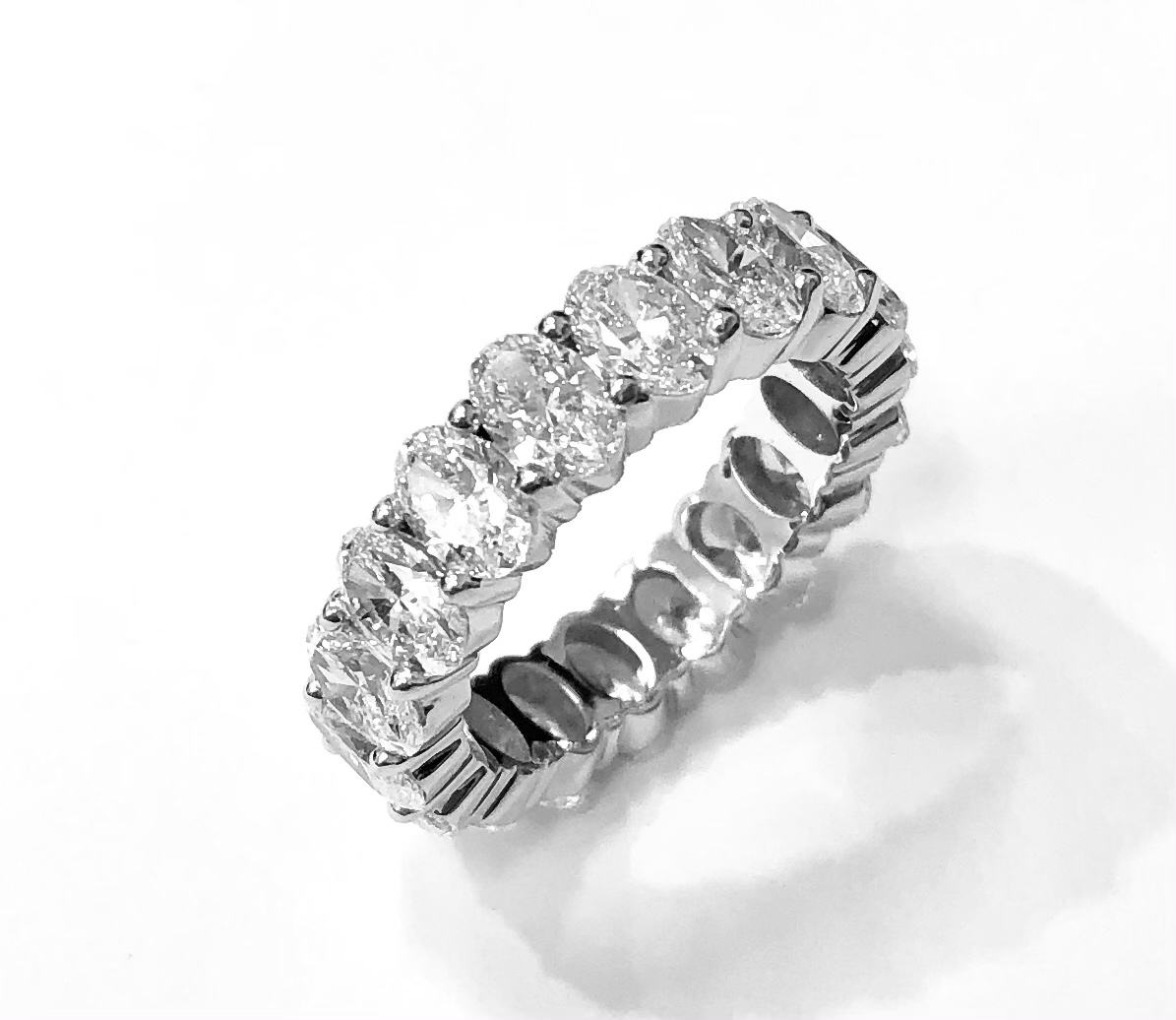 Oval diamond eternity band in a white metal setting